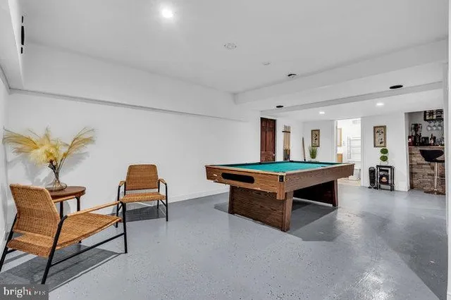 a room with furniture and air hockey table