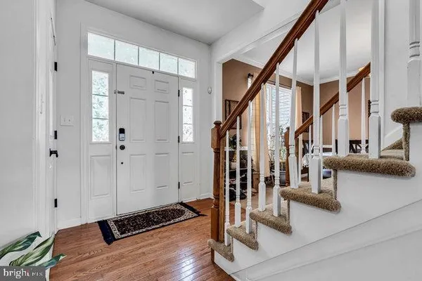 a view of an entryway with wooden floor and staircase