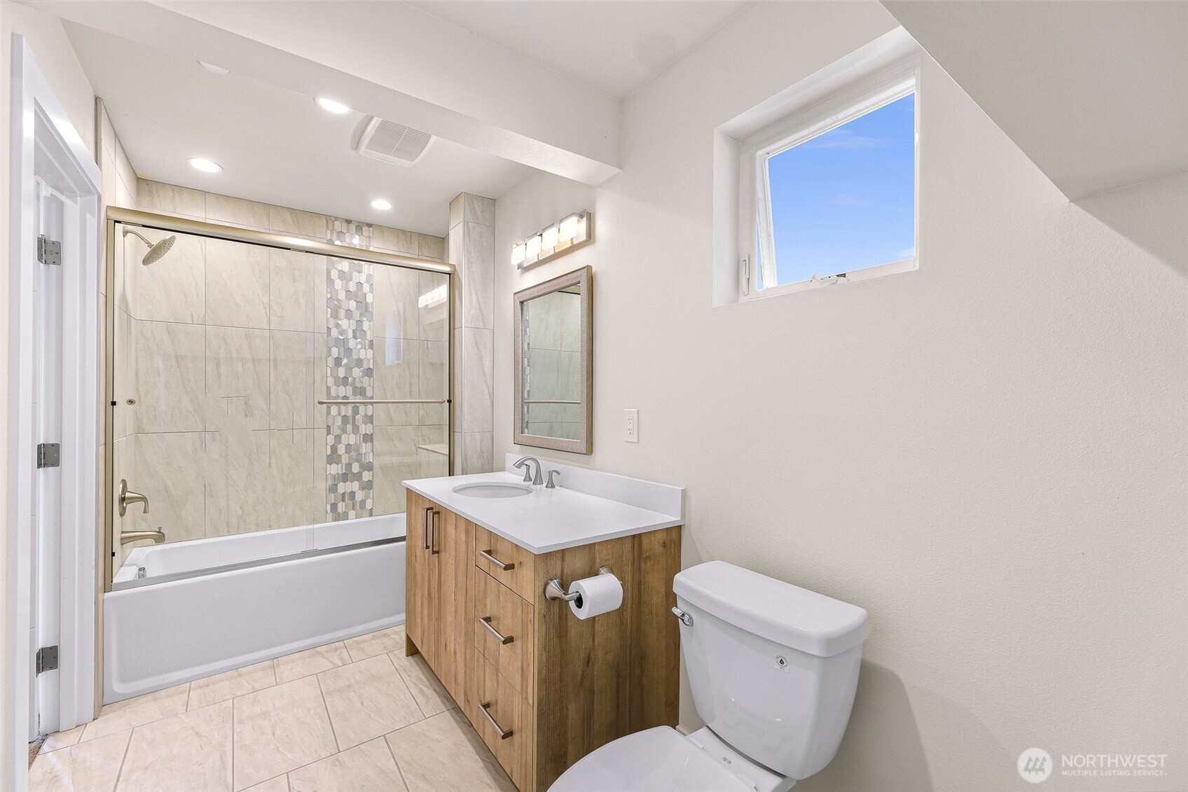 12065 30th Avenue Southwest Burien, WA 98146 - Photo 26 of 40 a bathroom with a granite countertop toilet a sink and a bathtub