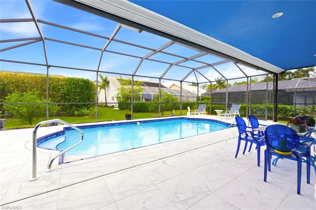 209 Countryside Drive Naples, FL 34104 - Photo 28 of 50 Outdoor pool featuring a sunroom, a lanai, a yard, and a patio area