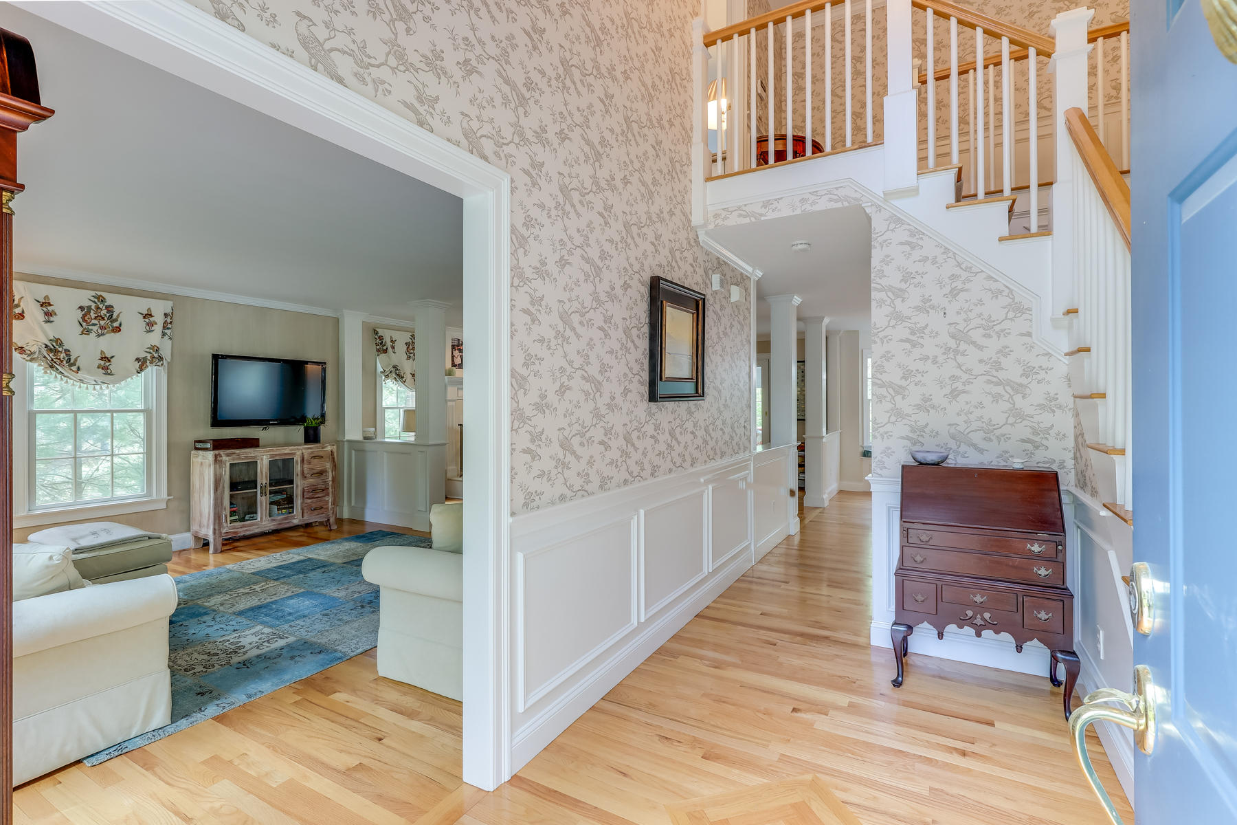 117 Wild Goose Way Centerville, MA 02632 - Photo 13 of 51 a hall way with furniture a flat screen tv and a fireplace