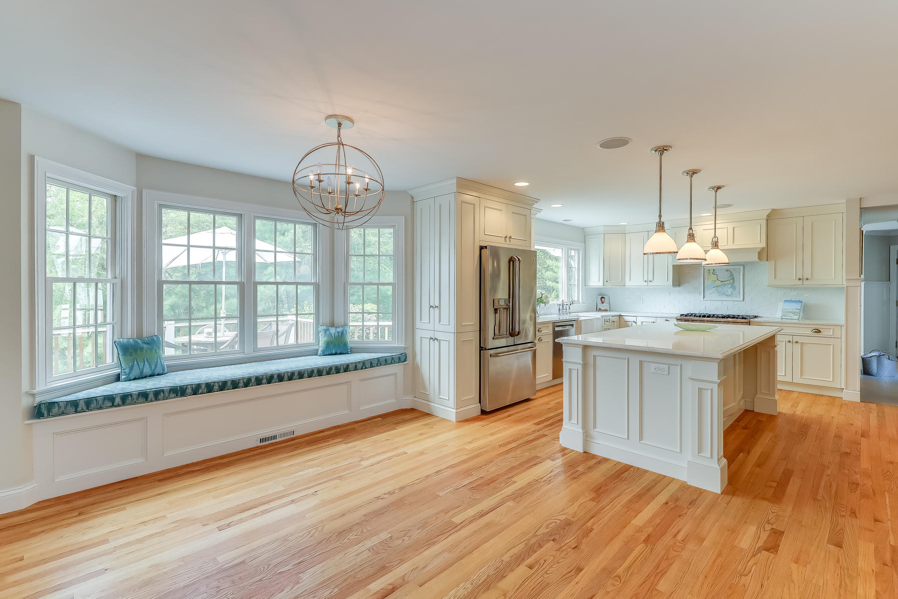 117 Wild Goose Way Centerville, MA 02632 - Photo 8 of 51 a large kitchen with kitchen island a large window a sink and stainless steel appliances