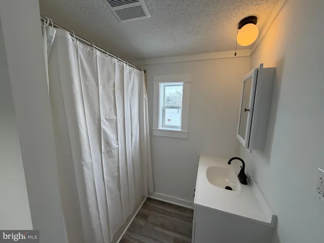 a bathroom with a sink and mirror