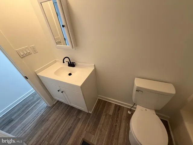 a bathroom with a toilet sink and mirror
