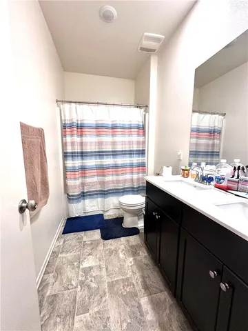 a bathroom with a tub sink and mirror