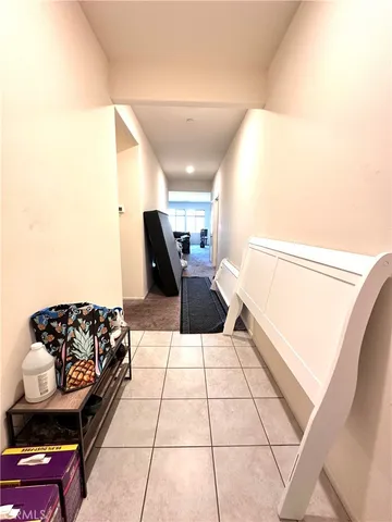 a hallway with a couch and a potted plant