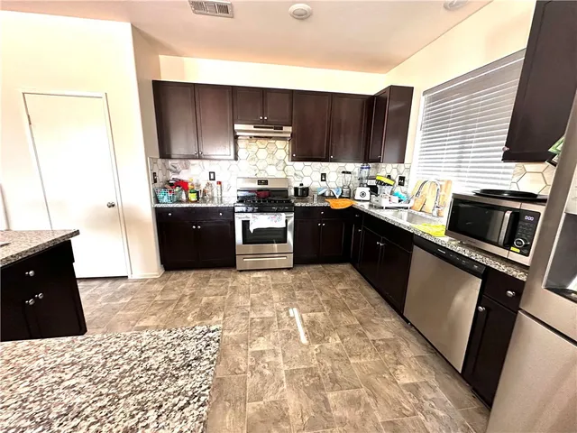 a living room with furniture a window and a flat screen tv