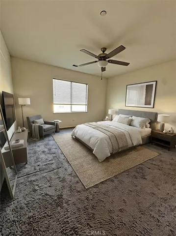 a bedroom with bed couch and window