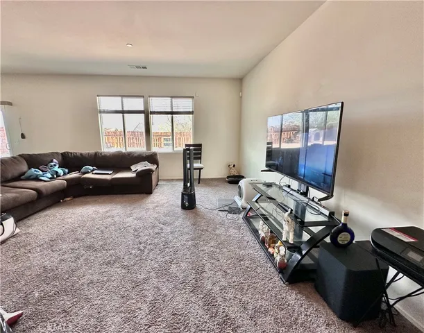 a view of a dining room with furniture and a window