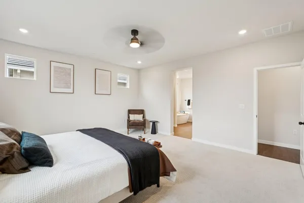 a bedroom with a bed and a painting