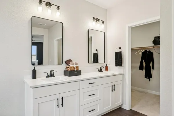 a bathroom with a double vanity sink and a mirror