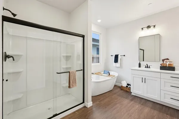a bathroom with a double vanity sink a mirror and a shower