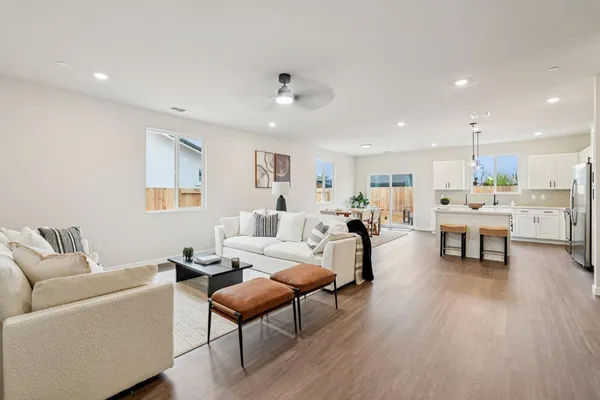 a living room with furniture and kitchen view