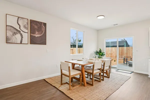 a view of a dining room with furniture and wooden floor