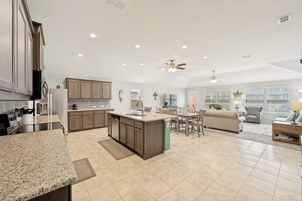3905 Bridle Path Lane Sanger, TX 76266 - Photo 3 of 26 a large kitchen with a large counter top furniture a sink and appliances