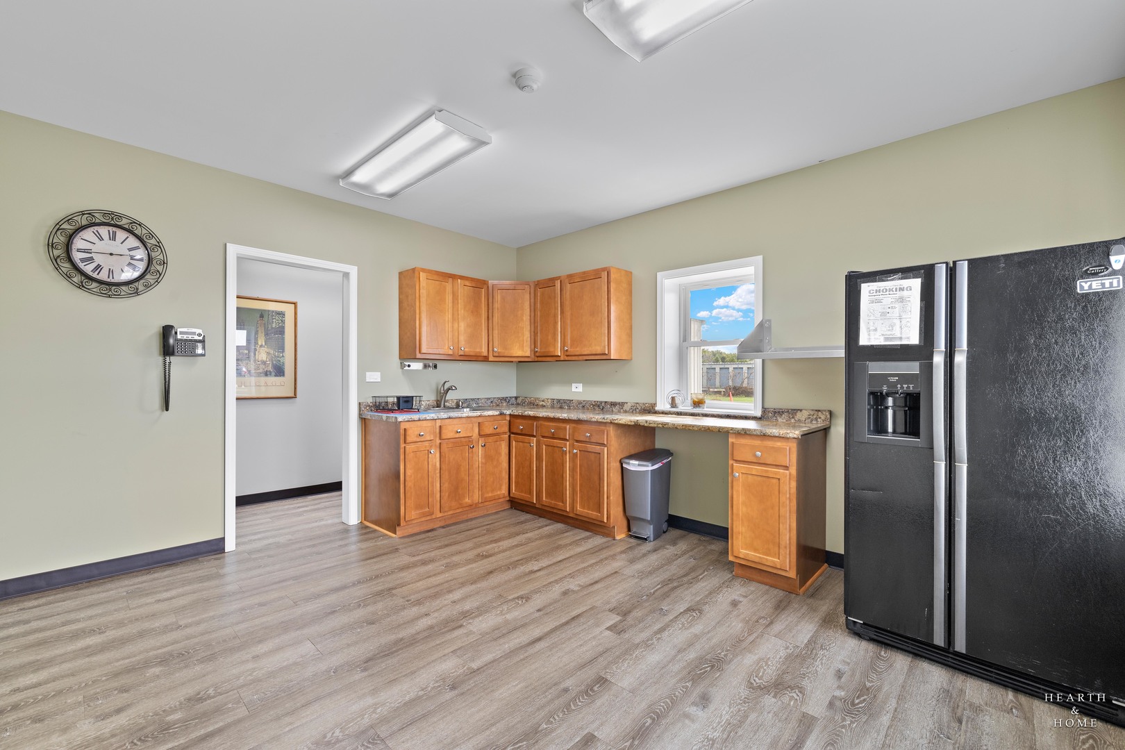 5214 State Rte 31 Crystal Lake, IL 60012 - Photo 11 of 30 a kitchen with granite countertop a refrigerator and wooden floor