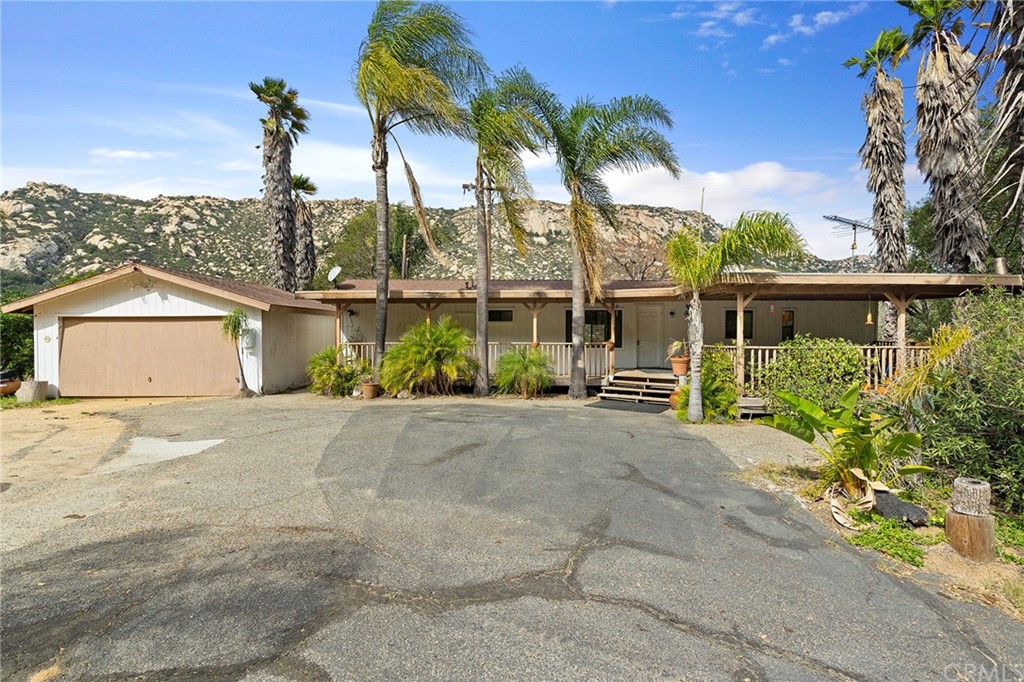 46970 Rainbow Canyon Road Temecula, CA 92592 - Photo 2 of 34 a view of a house with a yard and potted plants