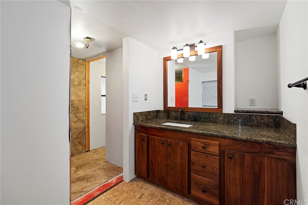 46970 Rainbow Canyon Road Temecula, CA 92592 - Photo 21 of 34 a bathroom with a granite countertop sink and a mirror