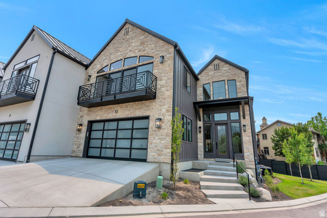 250 South Main Street, Unit 10 Alpine, UT 84004 - Photo 1 of 29 Contemporary stone and vertical siding exterior with a prominent arched window and a private balcony featuring a decorative metal railing