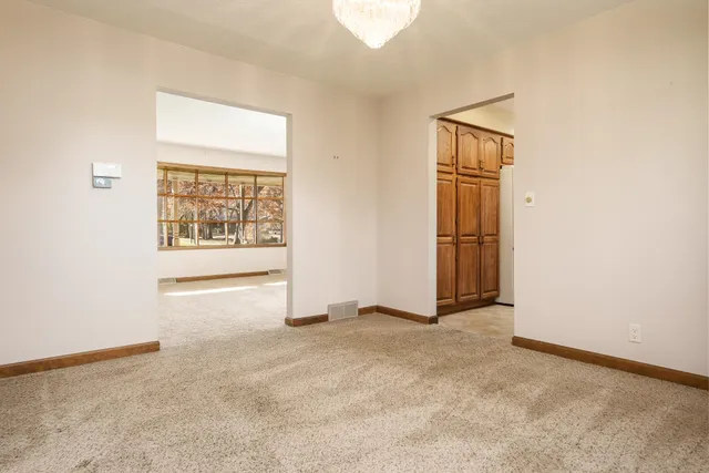 a room with a refrigerator and a television