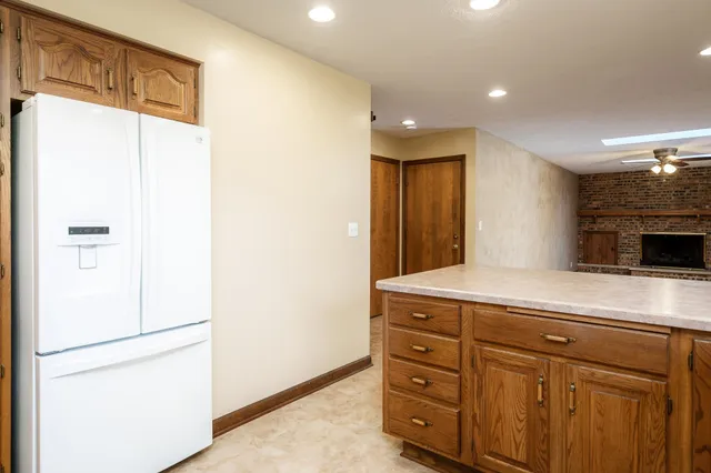 a kitchen with stainless steel appliances granite countertop a sink and a refrigerator