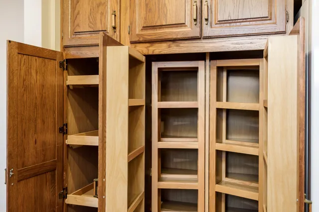 a view of an empty room with a fireplace and a window
