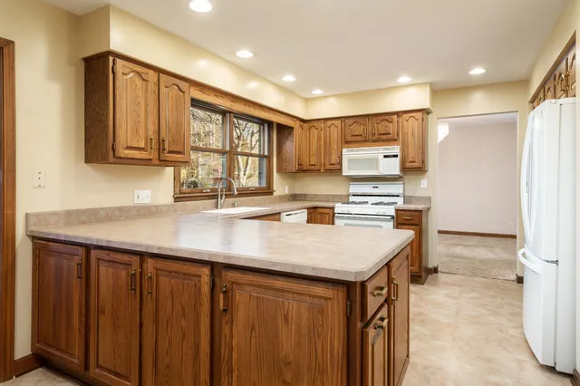 a view of empty room with wooden floor and fireplace