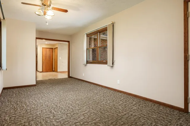 a view of a room with chairs and table in a patio