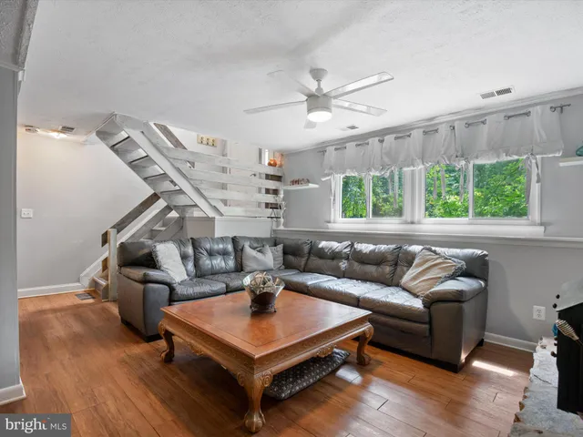 a room with pool table and windows