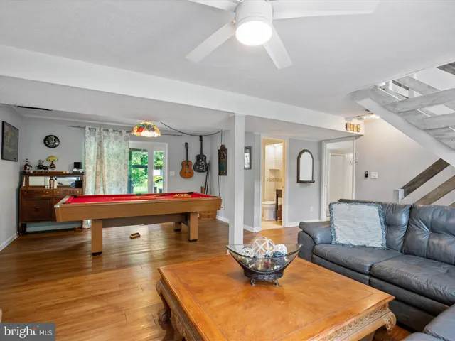 a bathroom with a granite countertop sink a mirror and a shower