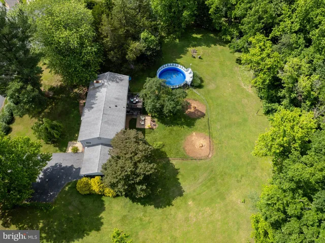a view of a backyard with swimming pool