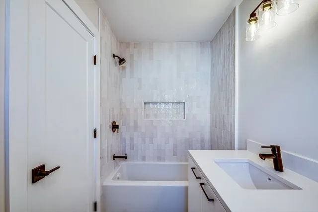 a bathroom with a sink a bathtub and shower