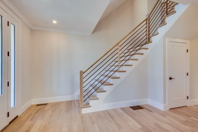 wooden floor in an empty room with stairs