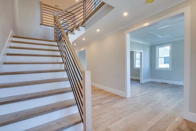 a view of entryway and hall with wooden floor