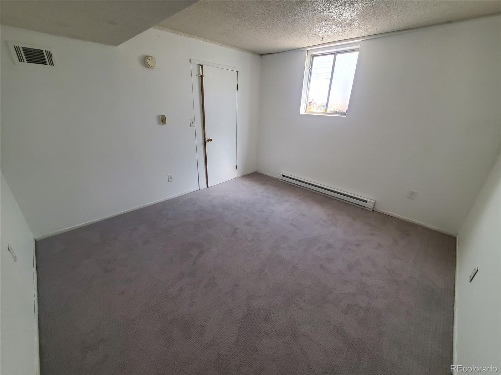 1012 State Street Fort Morgan, CO 80701 - Photo 8 of 18 a view of an empty room with a window