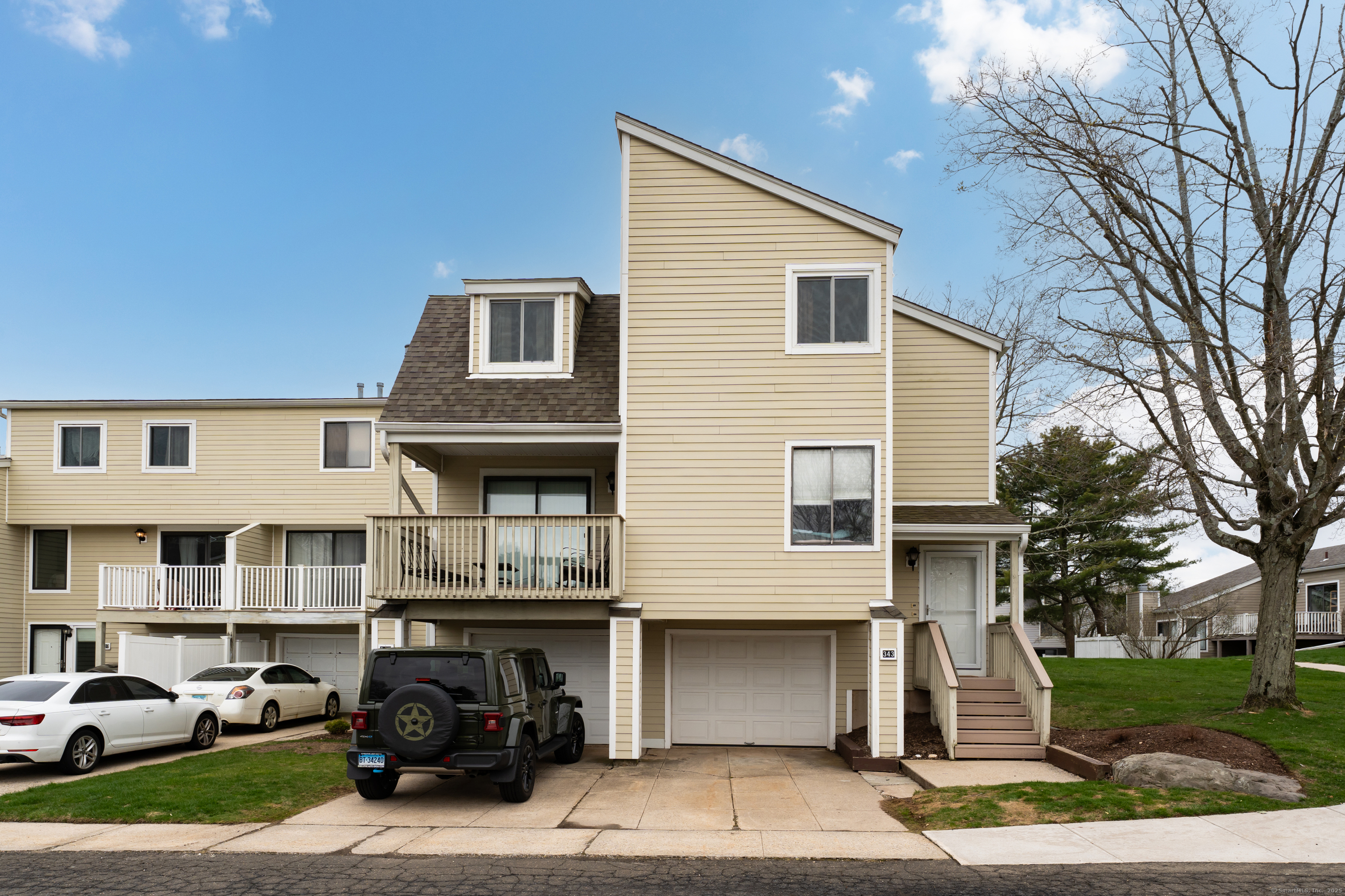 Welcome to 341 Walden Green. Unit on top level; garage bay to left.