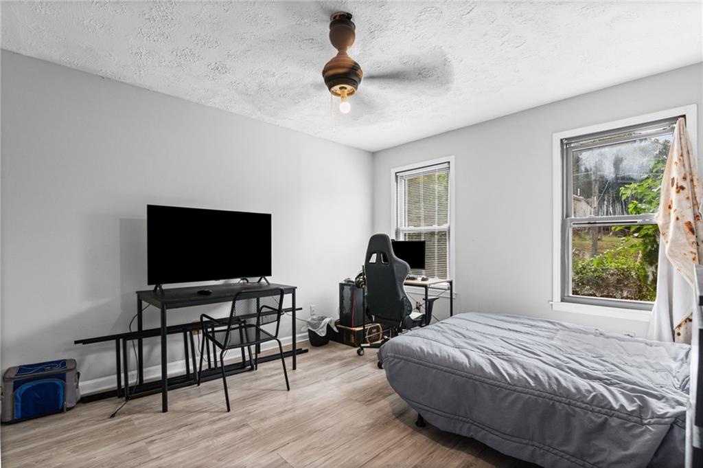 877 Beckwith Street Southwest Atlanta, GA 30314 - Photo 13 of 28 a bedroom with bed tv and table