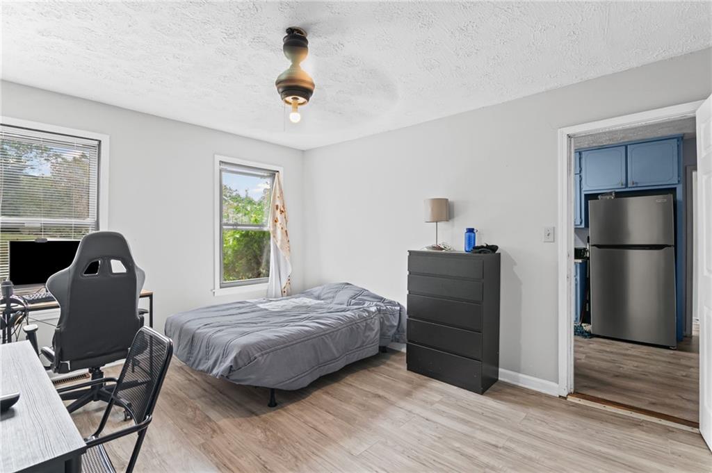 877 Beckwith Street Southwest Atlanta, GA 30314 - Photo 14 of 28 a bedroom with a bed and a chair