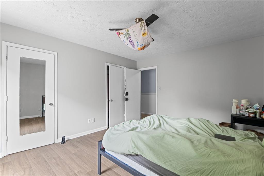 877 Beckwith Street Southwest Atlanta, GA 30314 - Photo 16 of 28 a bedroom with a bed and a chandelier