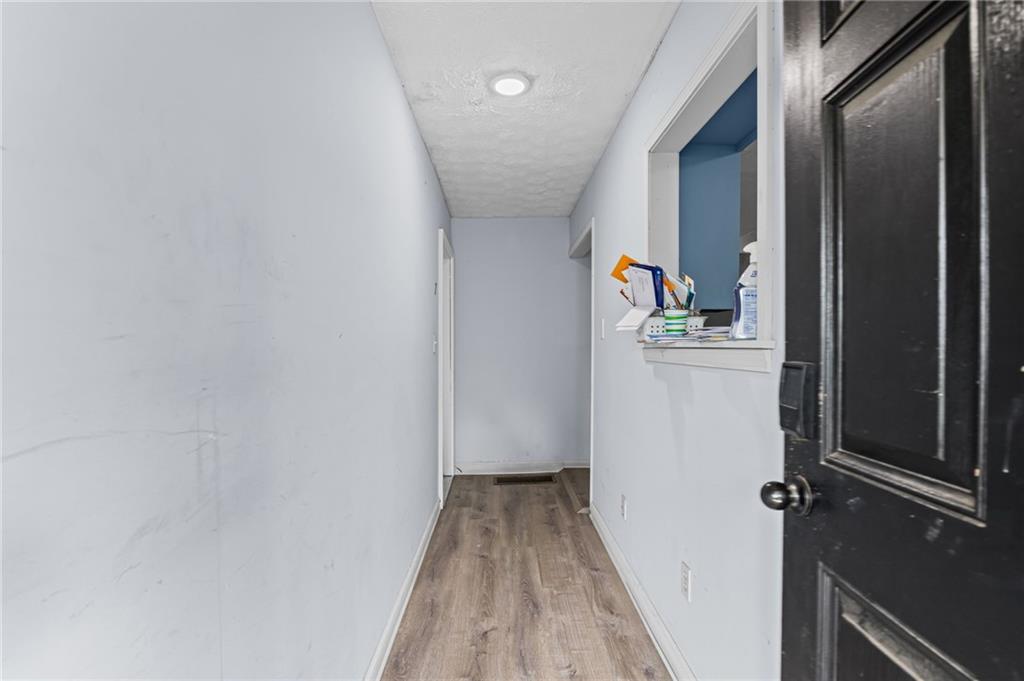 877 Beckwith Street Southwest Atlanta, GA 30314 - Photo 4 of 28 a view of a hallway with wooden floor and staircase