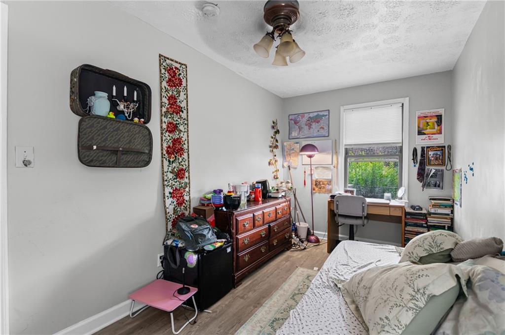 877 Beckwith Street Southwest Atlanta, GA 30314 - Photo 5 of 28 a bedroom with furniture and a window