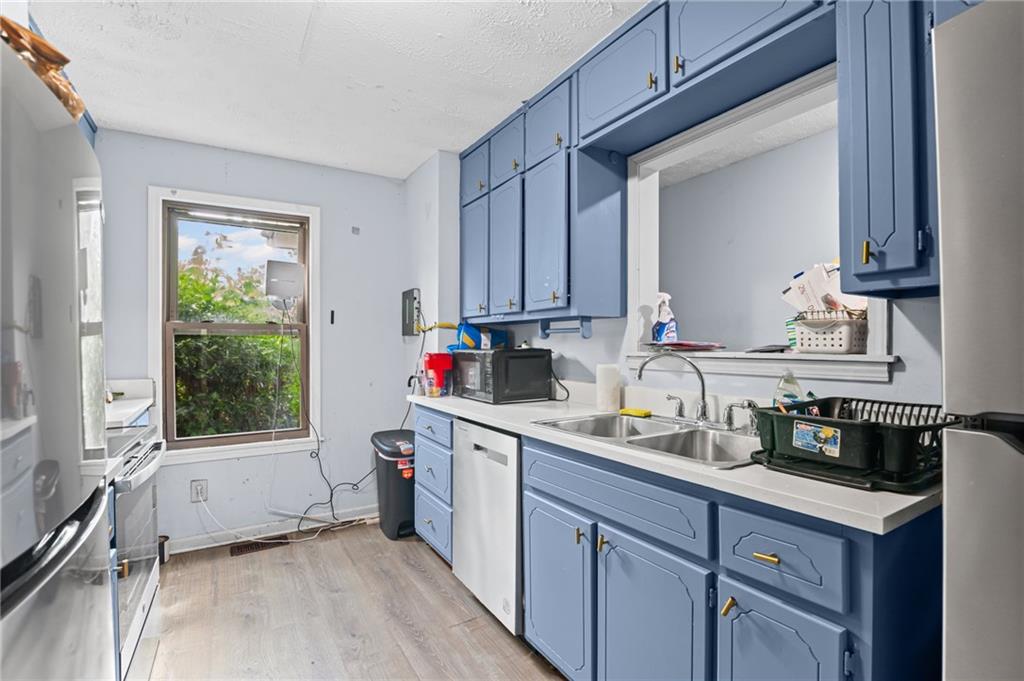 877 Beckwith Street Southwest Atlanta, GA 30314 - Photo 7 of 28 a kitchen with a sink cabinets and window