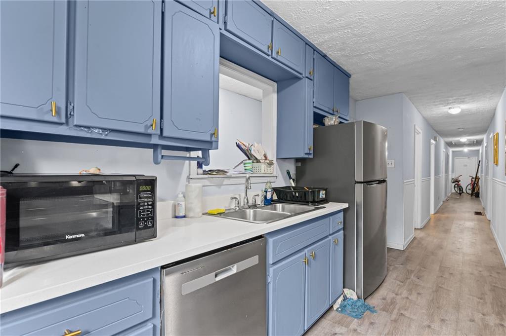 877 Beckwith Street Southwest Atlanta, GA 30314 - Photo 8 of 28 a kitchen with refrigerator a stove and cabinets