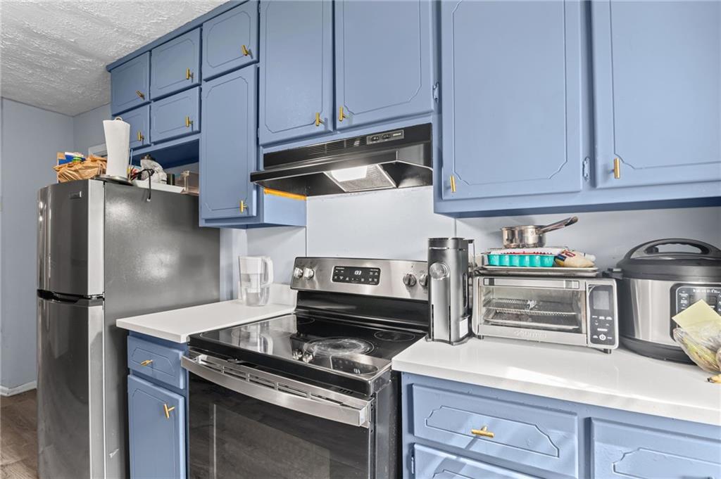 877 Beckwith Street Southwest Atlanta, GA 30314 - Photo 9 of 28 a kitchen with stainless steel appliances granite countertop a refrigerator stove and sink