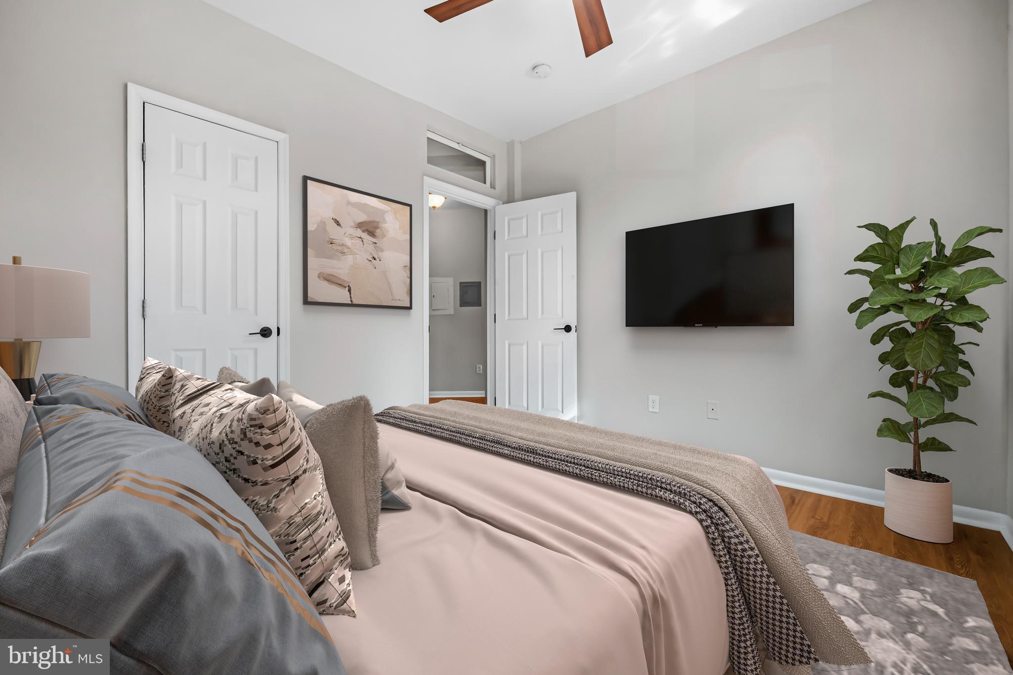 5 Rhode Island Avenue Northwest, Unit 202 Washington, DC 20001 - Photo 9 of 17 a bedroom with a bed and a flat screen tv