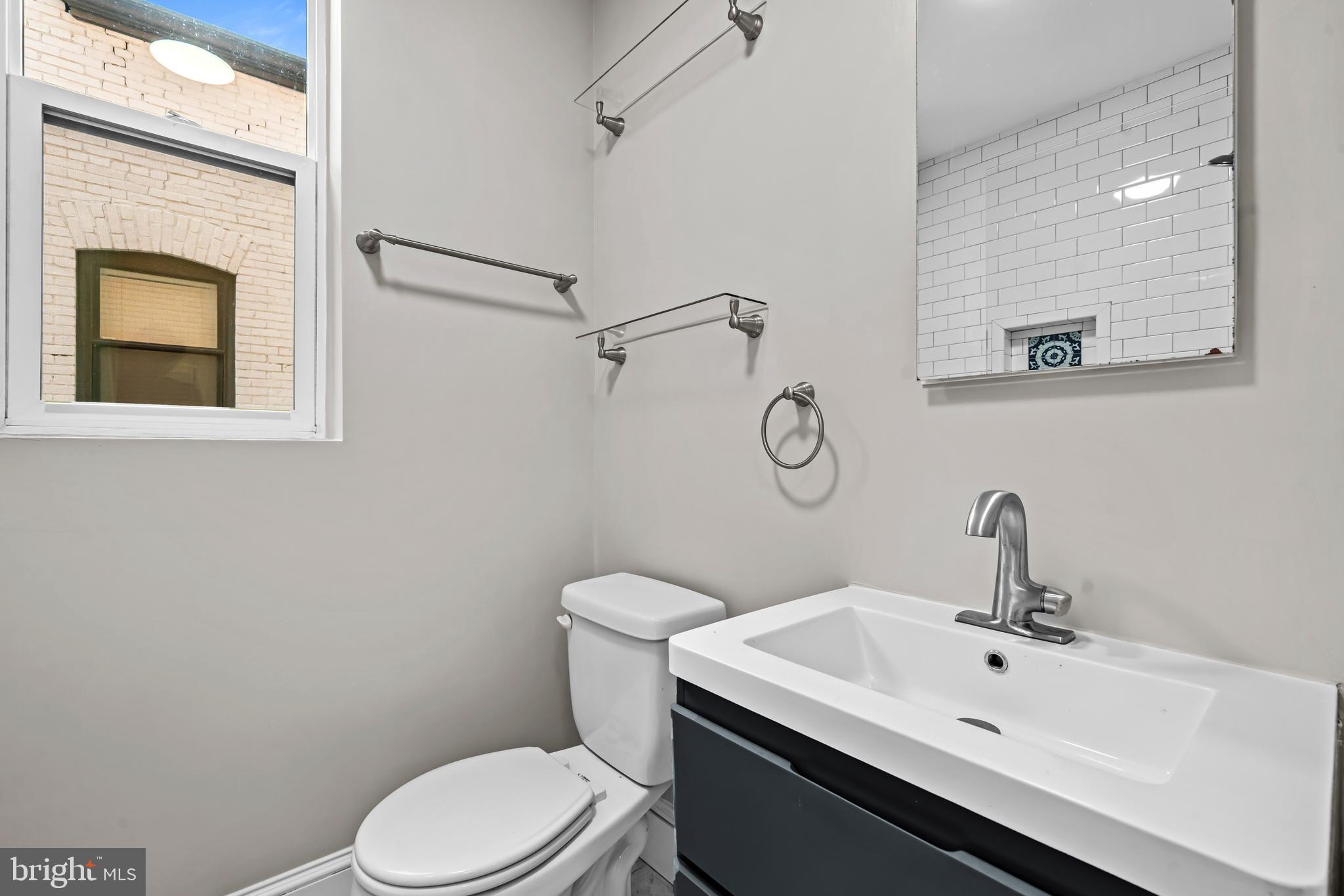 5 Rhode Island Avenue Northwest, Unit 202 Washington, DC 20001 - Photo 13 of 17 a bathroom with a sink mirror and toilet