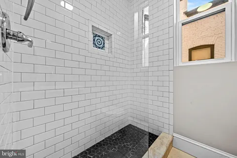 a bathroom with a sink mirror and toilet