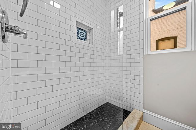 a bathroom with a sink mirror and toilet