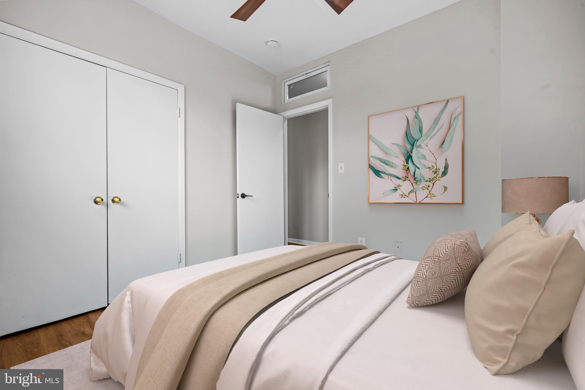 5 Rhode Island Avenue Northwest, Unit 202 Washington, DC 20001 - Photo 7 of 17 a bedroom with a bed and a painting on the wall