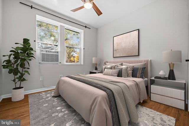 a bedroom with furniture and a potted plant